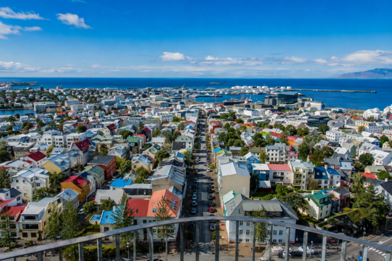 Colorful rooftops of downtown Reykjavik seen from Hallgr&iacute;mskirkja's tower, with the harbor and sea in the distance