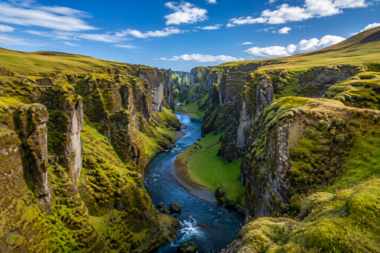 Fjadrargljufur canyon with a winding river between moss-covered walls