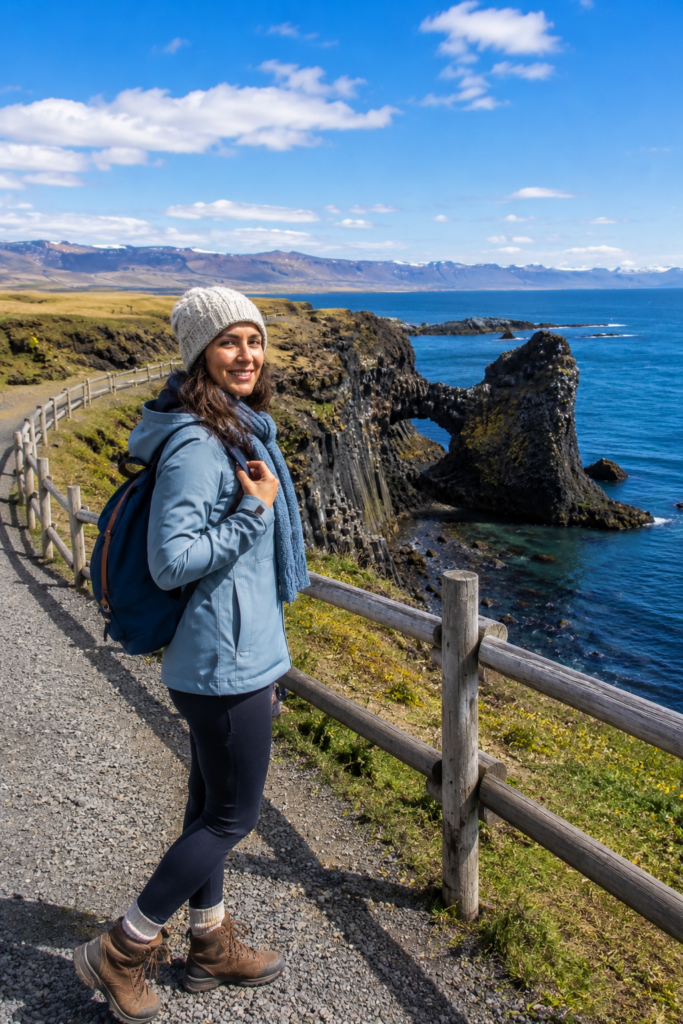 Woman walking the clifftop trail at Arnarstapi, Snæfellsnes Peninsula